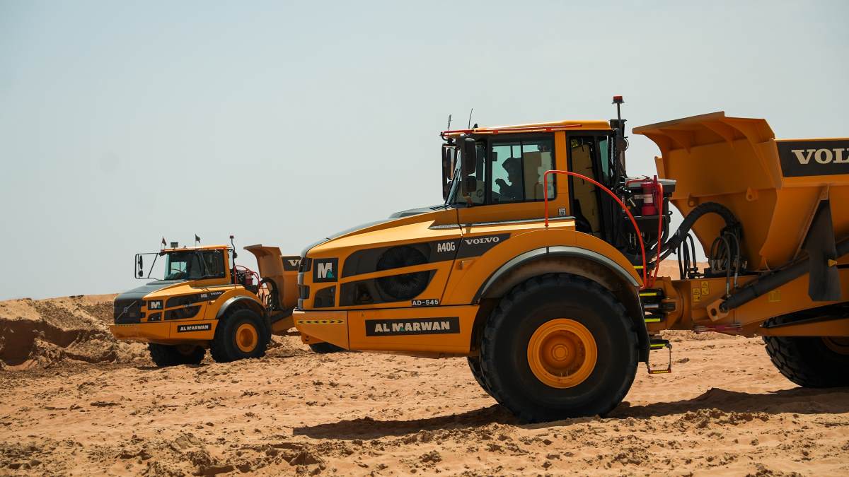 Two Volvo A40G dump trucks in action.