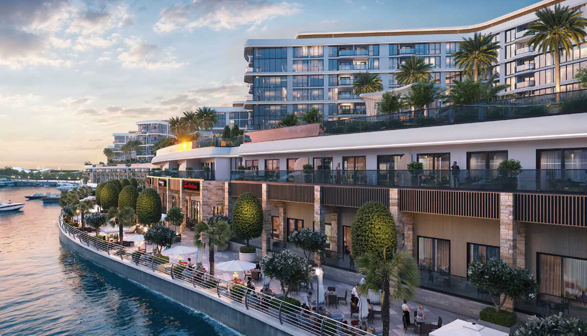 Luxury waterfront residential and retail development with promenade, palm trees, and marina views
