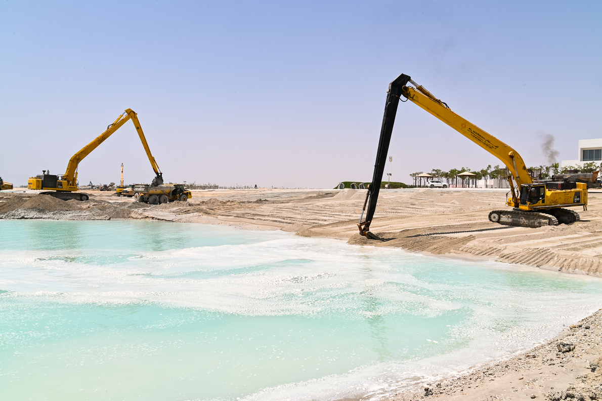 long-reach boom excavators at work on a construction site - Al Marwan Machinery