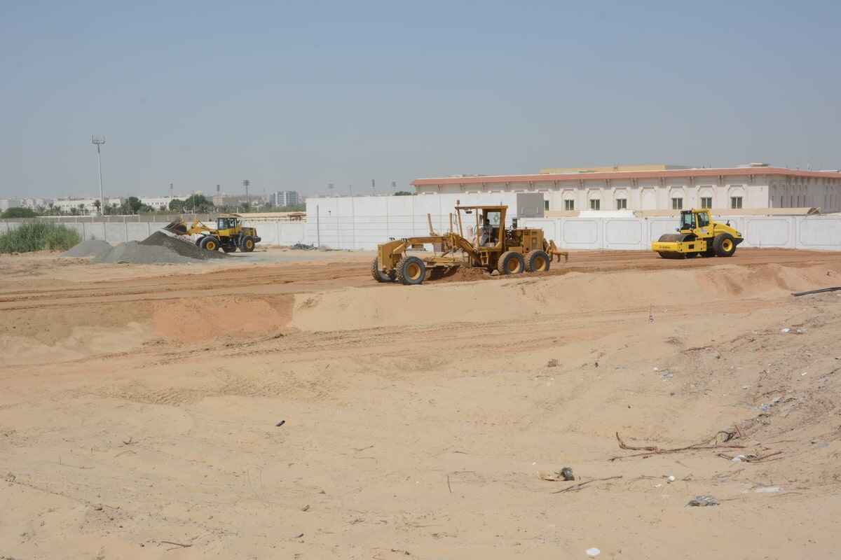 A vibratory soil compactor or single drum roller follows the grader as a first phase in compaction