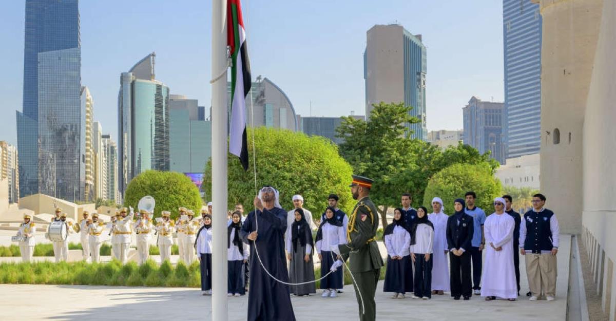 Sheikh Mohamed bin Zayed Al Nahyan rising UAE flag