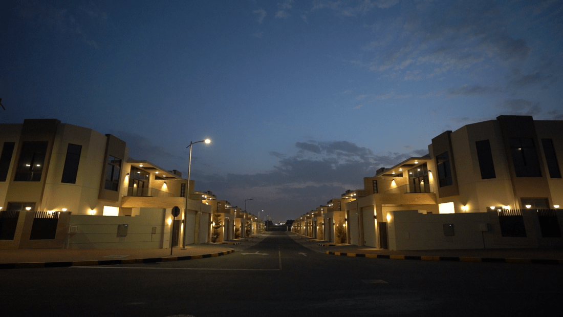 Night view of Tilal City townhouses by Al Marwan Development